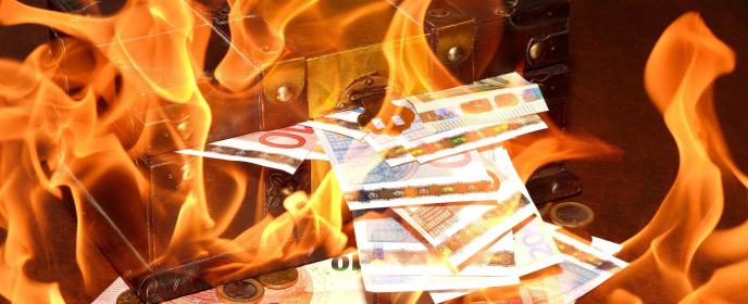 Hořící bankovky, inflace - ilustrační foto