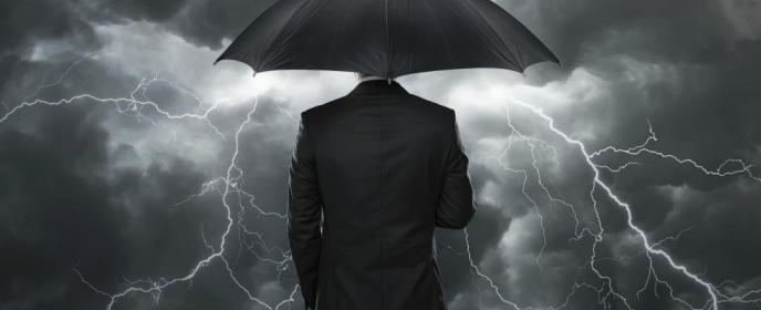 Tržní počasí, bouře, investor s deštníkem, ochrana proti krachu - ilustrační foto